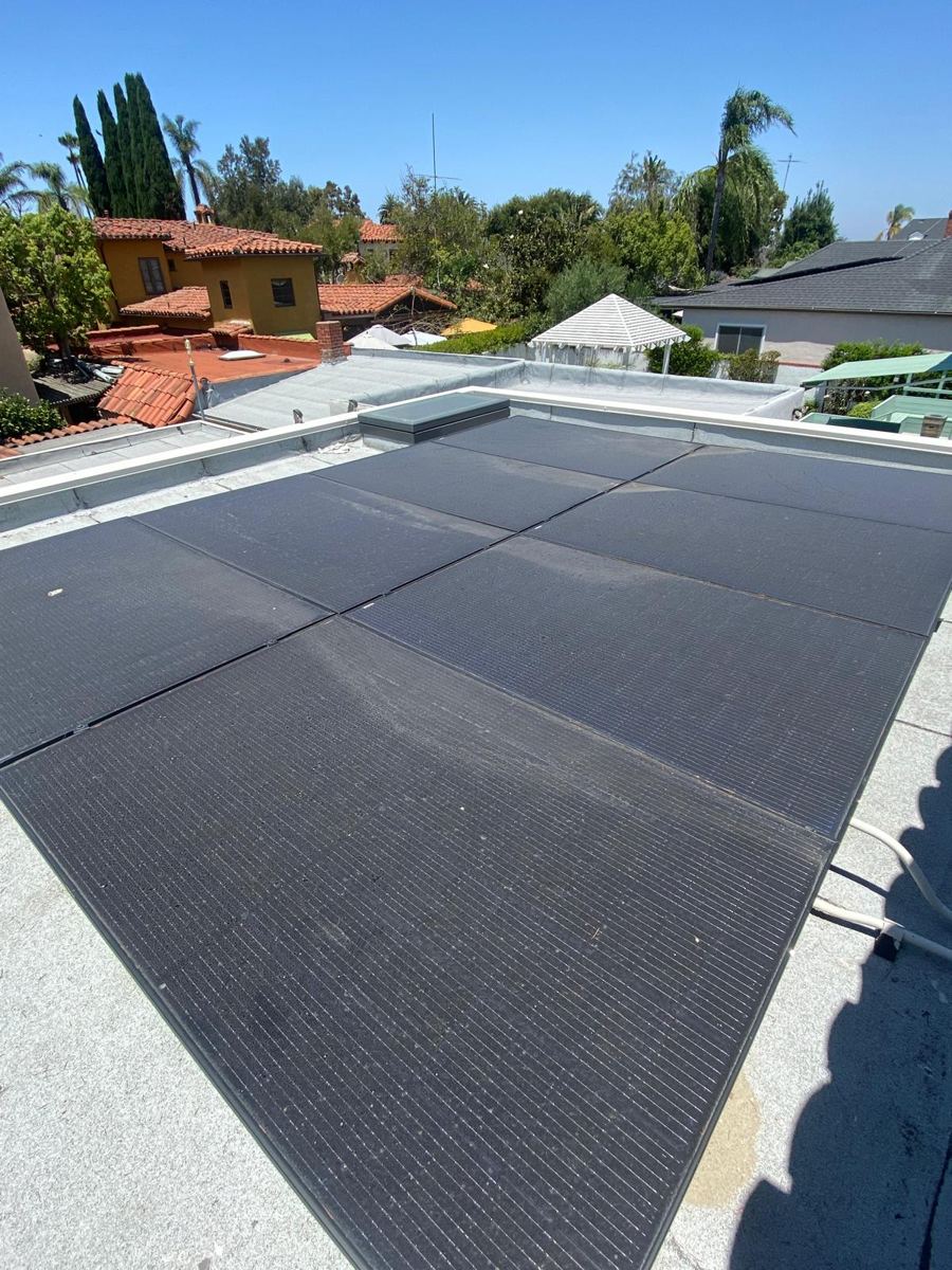 Dusty solar panels on a flat roof, before cleaning