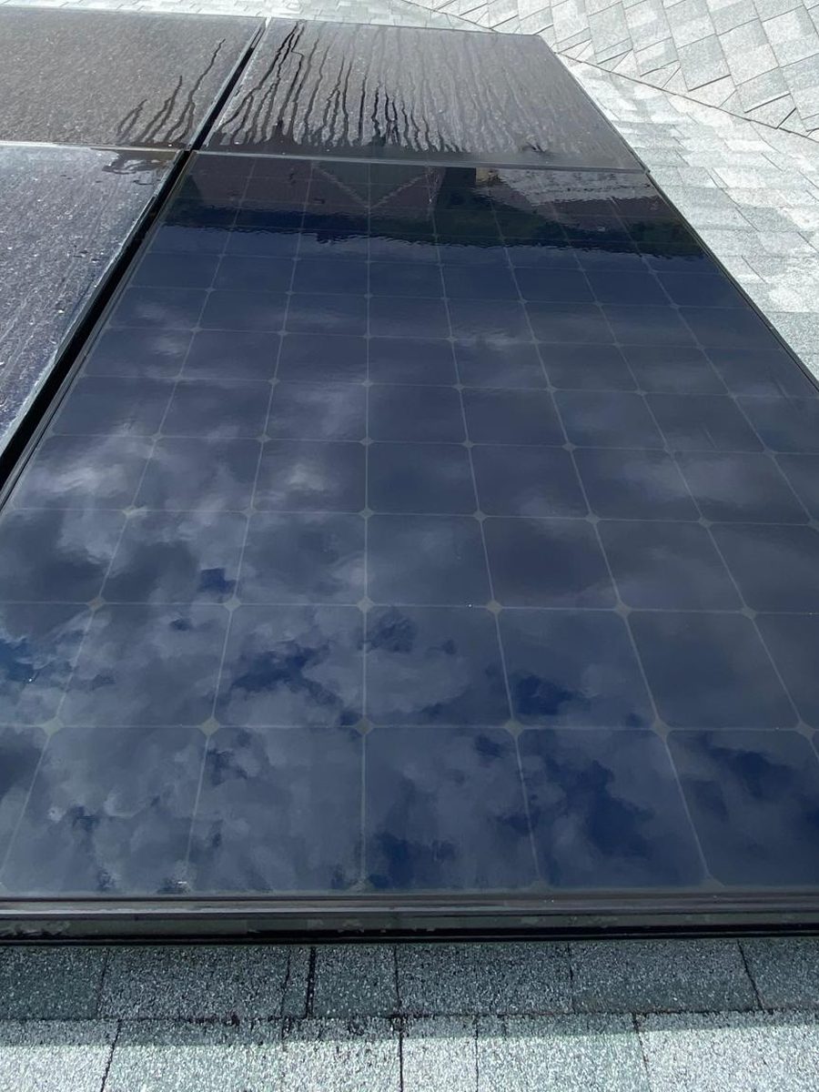 The same panel after cleaning, next to panels still dusty
